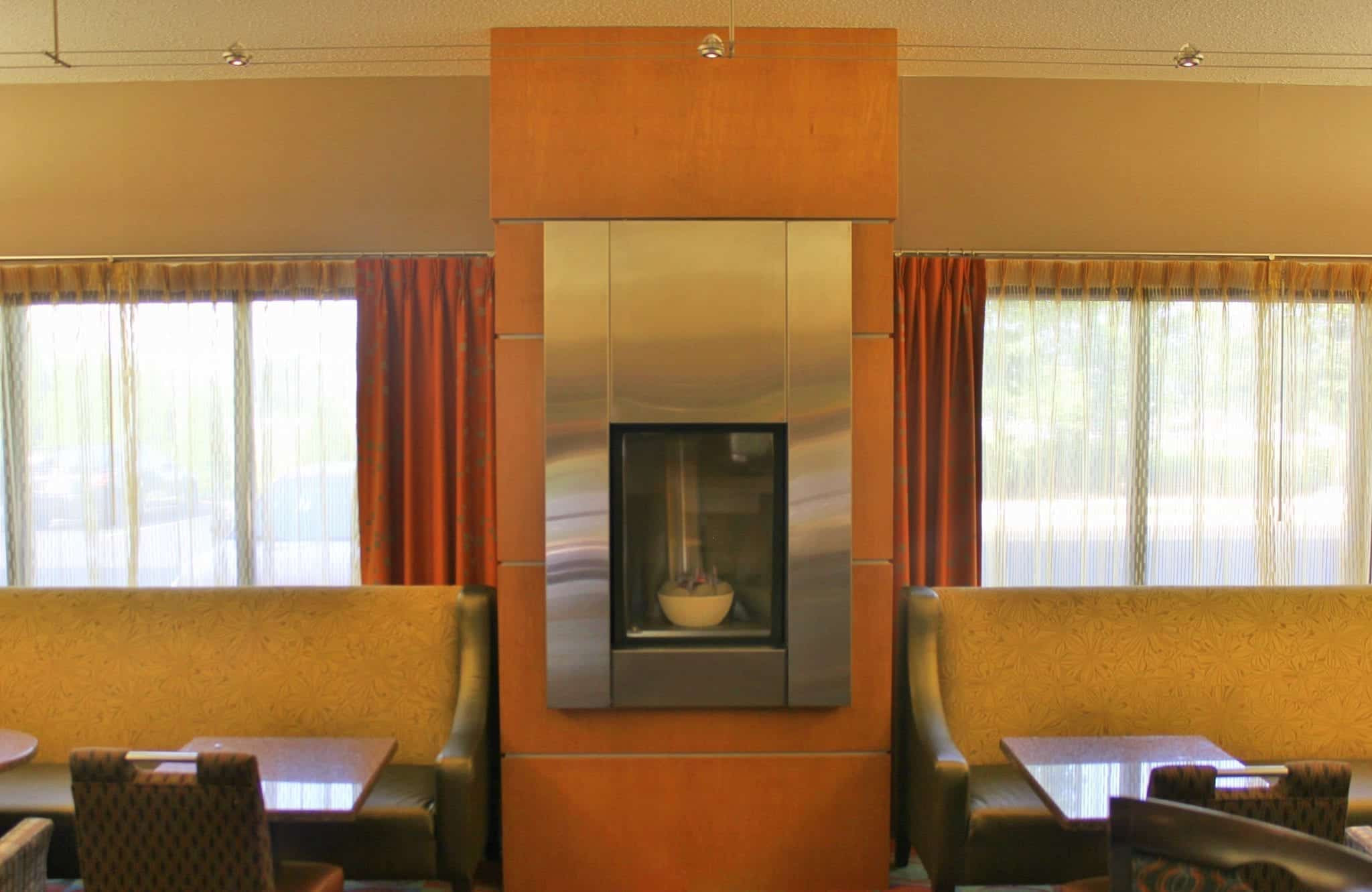 propane fireplace between dining tables