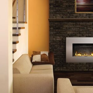 ptopane fireplace on brick wall near beige couches and stairwell
